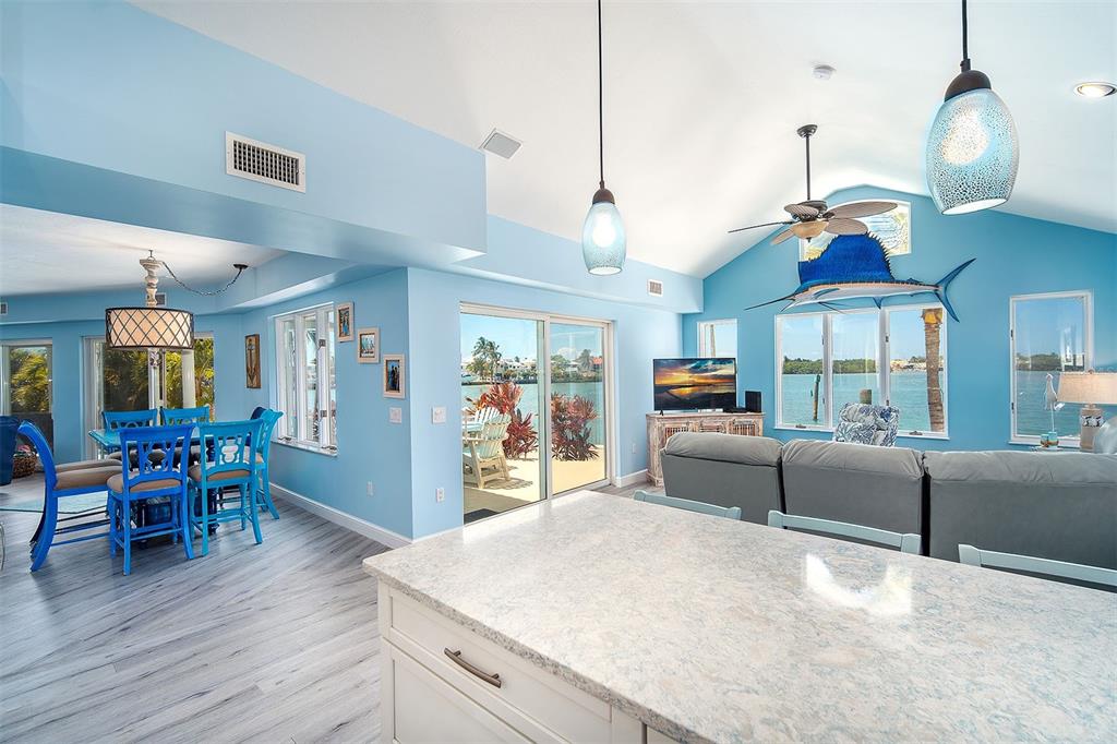 770 9th Street Key Colony Beach, FL 33051 - Photo 12 of 39 a living room with furniture a dining table and chairs with wooden floor