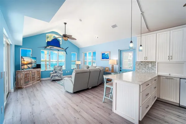 a living room with furniture and kitchen view