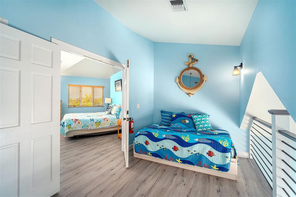 770 9th Street Key Colony Beach, FL 33051 - Photo 19 of 39 a bedroom with furniture and a wooden floor