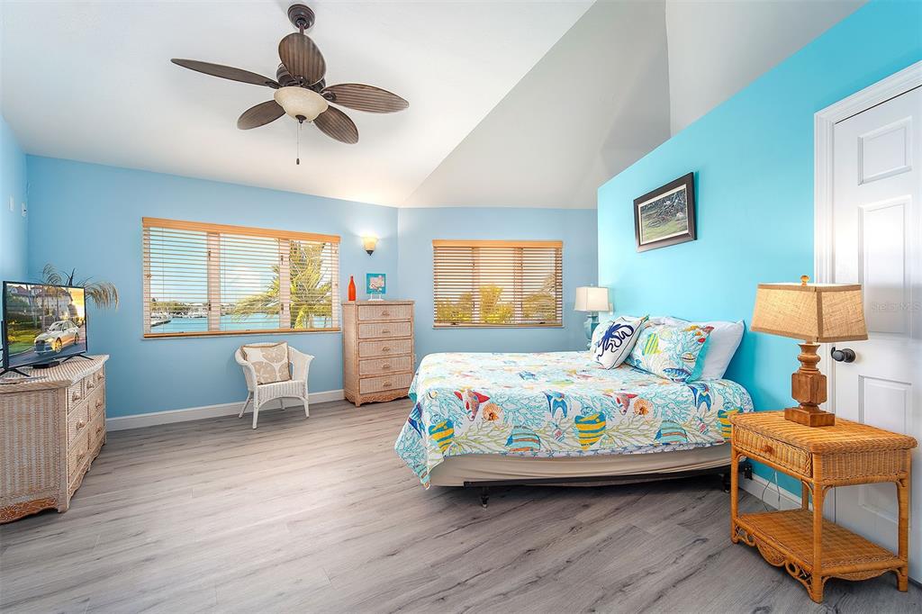 770 9th Street Key Colony Beach, FL 33051 - Photo 20 of 39 a bedroom with a bed and a chandelier