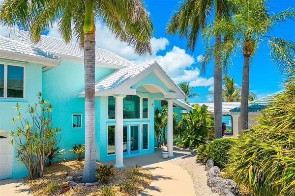 a view of a house with a palm tree