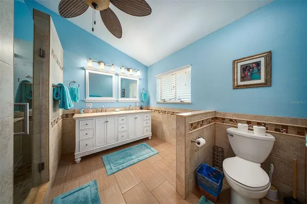 a bedroom with two beds and a chair