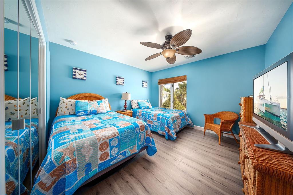770 9th Street Key Colony Beach, FL 33051 - Photo 22 of 39 a bedroom with two beds and a chair