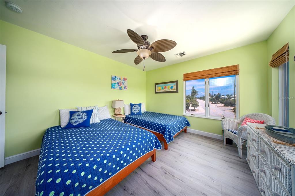 770 9th Street Key Colony Beach, FL 33051 - Photo 23 of 39 a bedroom with a bed and a chandelier