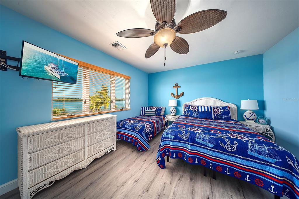 770 9th Street Key Colony Beach, FL 33051 - Photo 25 of 39 a bedroom with a large bed and a chandelier