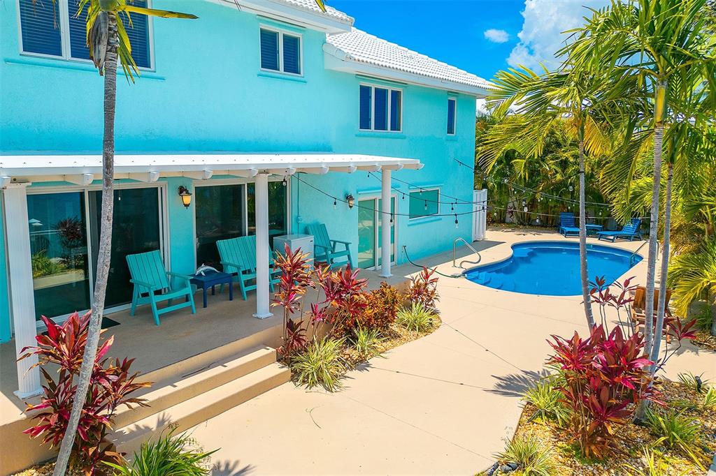 770 9th Street Key Colony Beach, FL 33051 - Photo 28 of 39 a view of a house with backyard patio and swimming pool