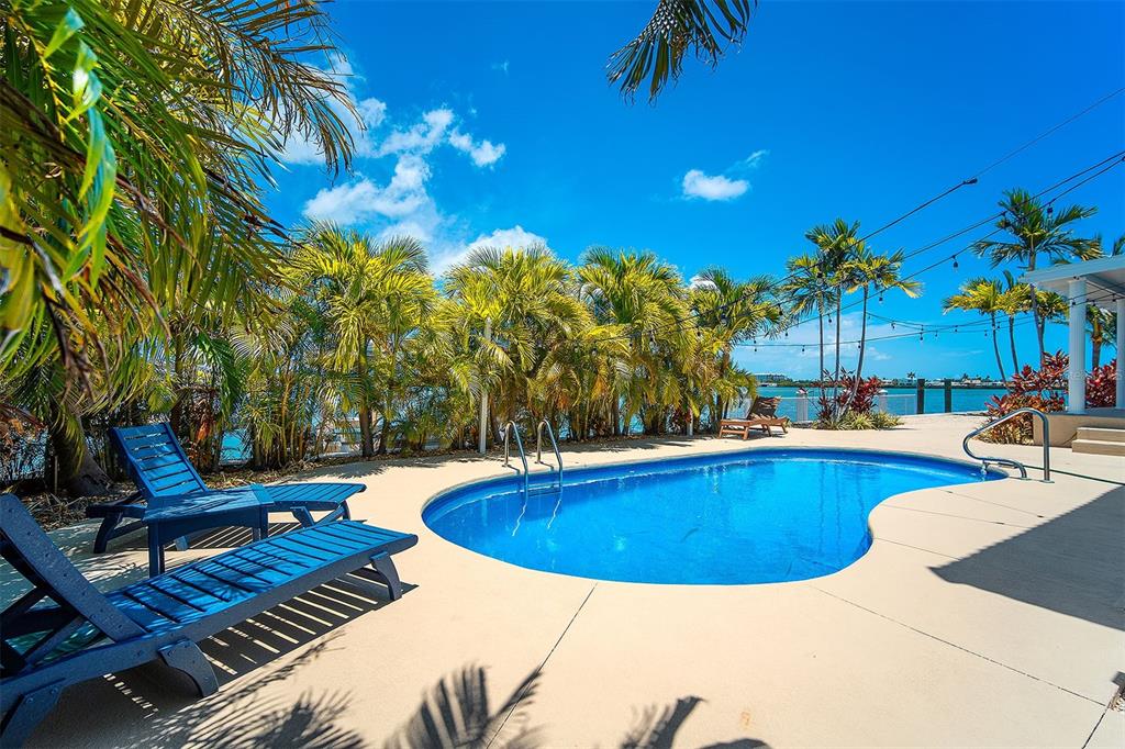 770 9th Street Key Colony Beach, FL 33051 - Photo 30 of 39 a view of a swimming pool with chairs