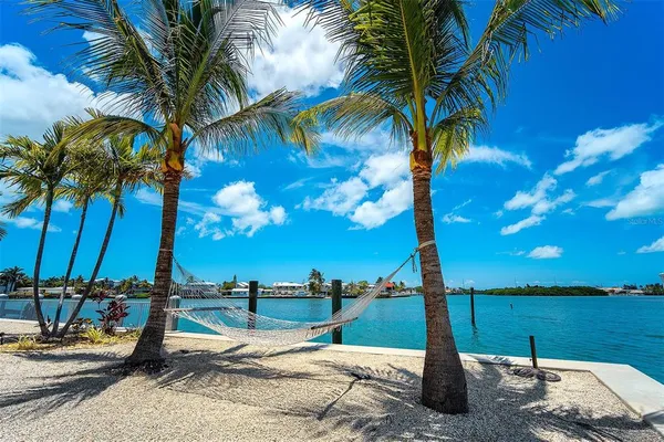a view of a lake with couches chairs and a table
