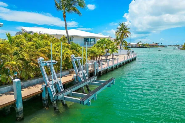 a view of a swimming pool with lawn chairs under an umbrella