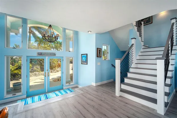 a view of entryway with wooden floor and windows
