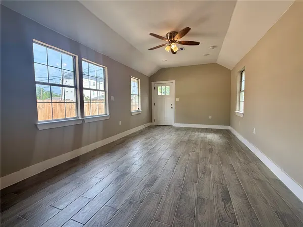 wooden floor in an empty room with a window