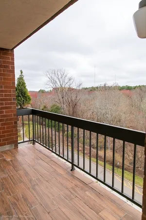 a balcony with wooden floor and fence