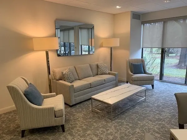 a living room with furniture and a large window