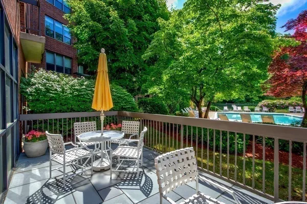 a view of a patio with couches table and chairs and potted plants