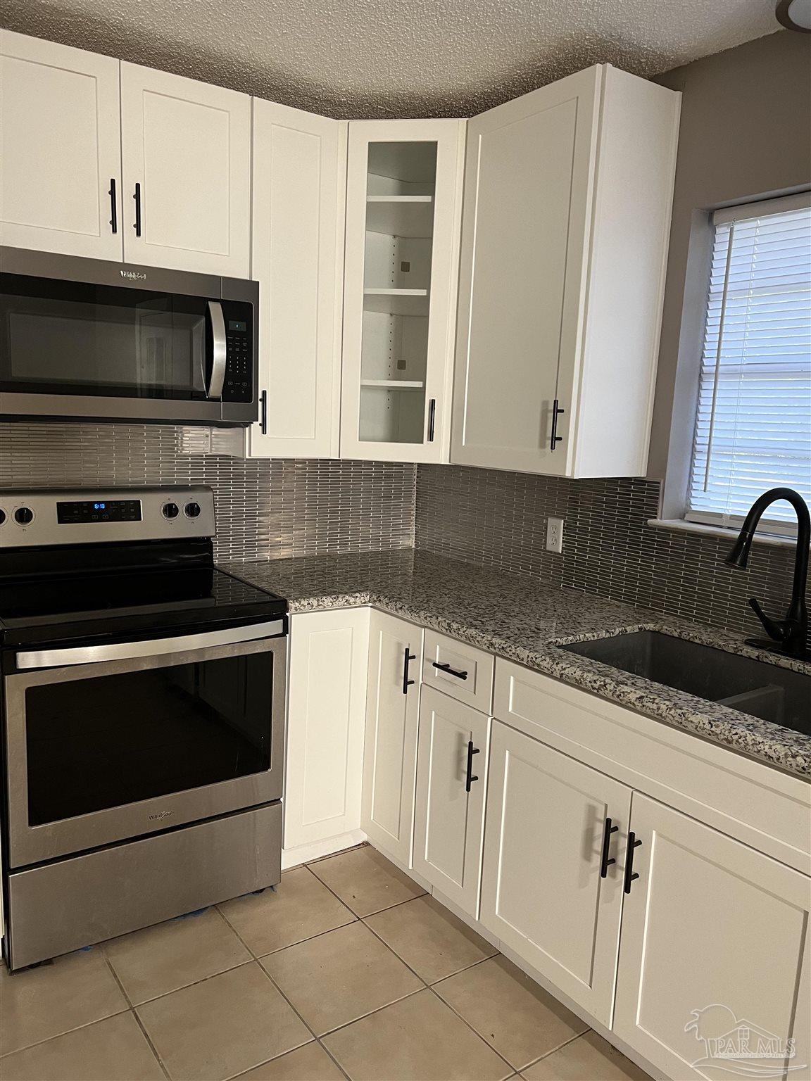 5180 Catalina Street Milton, FL 32571 - Photo 2 of 19 White cabinets, Granite