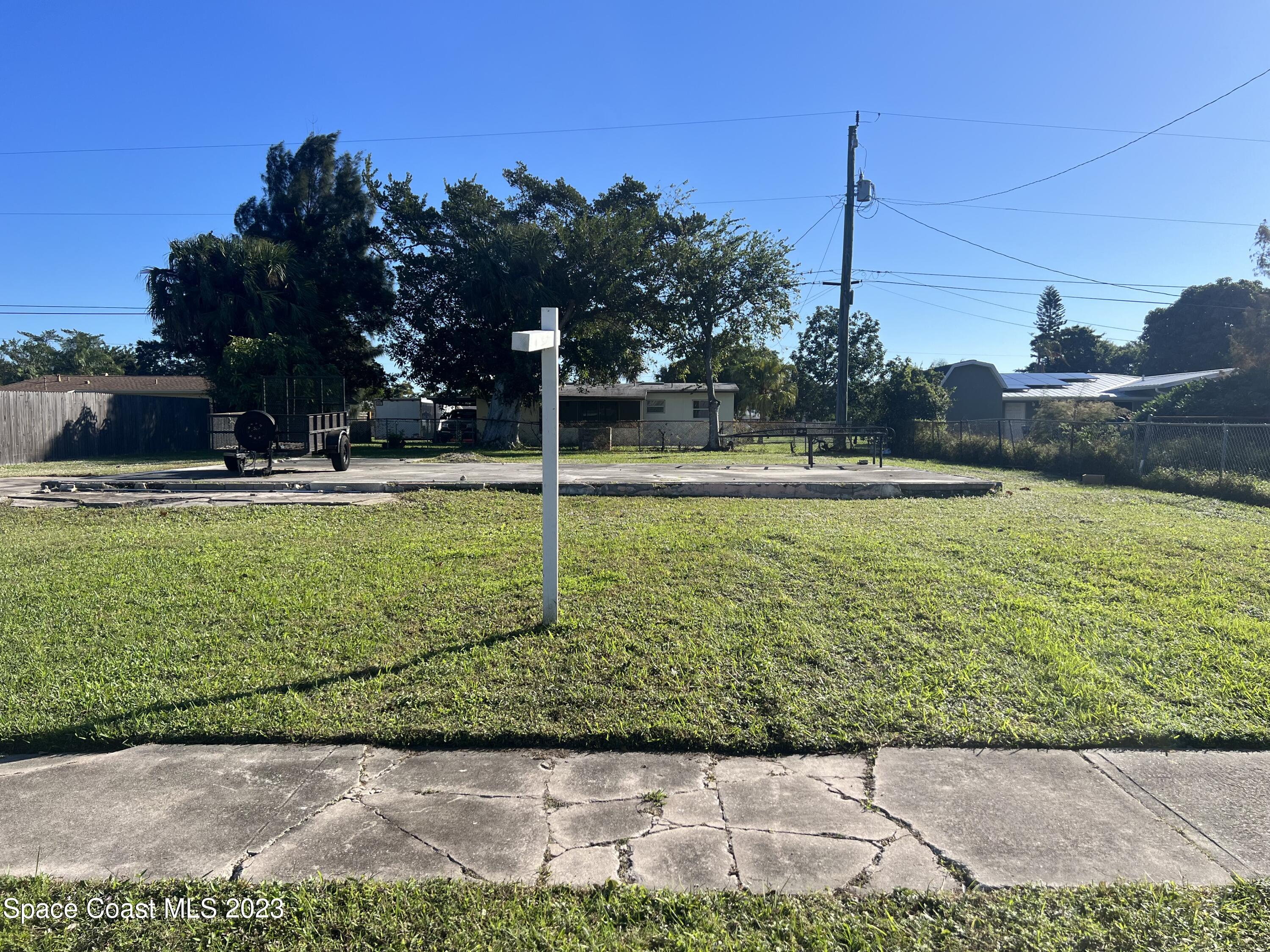 1140 Dunes Street Merritt Island, FL 32953 - Photo 2 of 3 a view of a swimming pool with a yard
