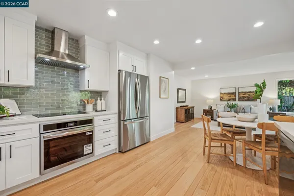 a kitchen with a potted plant on the counter and cabinets