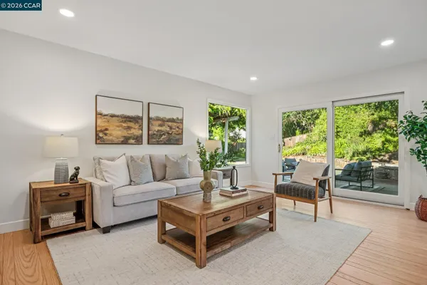 a living room with furniture and a potted plant