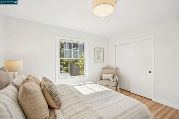 a bedroom with a bed and a window