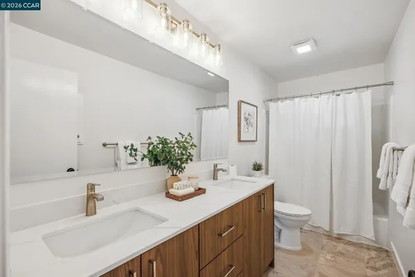 a view of a hallway with large windows and couches