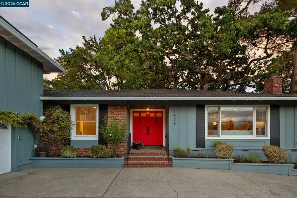 a front view of a house with garden