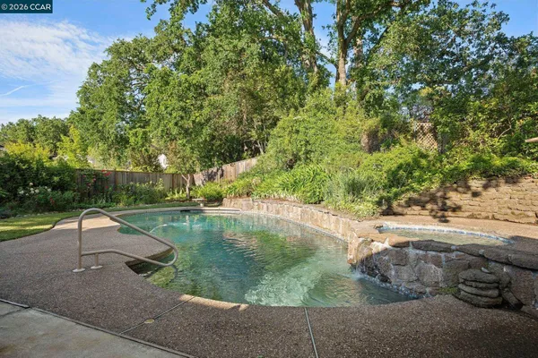 a view of a house with swimming pool and sitting area