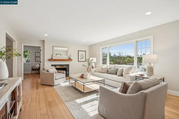 a living room with furniture a fireplace and a table