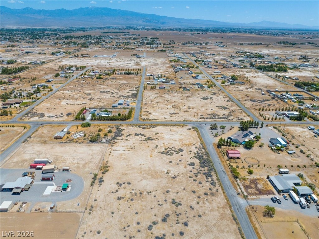 4580 Lawrence Road Pahrump, NV 89048 - Photo 37 of 40 Panoramic views of vast, undeveloped land with distant mountains under a clear sky.