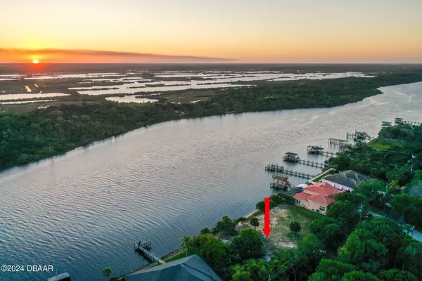 a aerial view of lake and residential houses with outdoor space