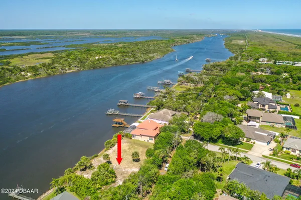 an aerial view of a houses with a yard