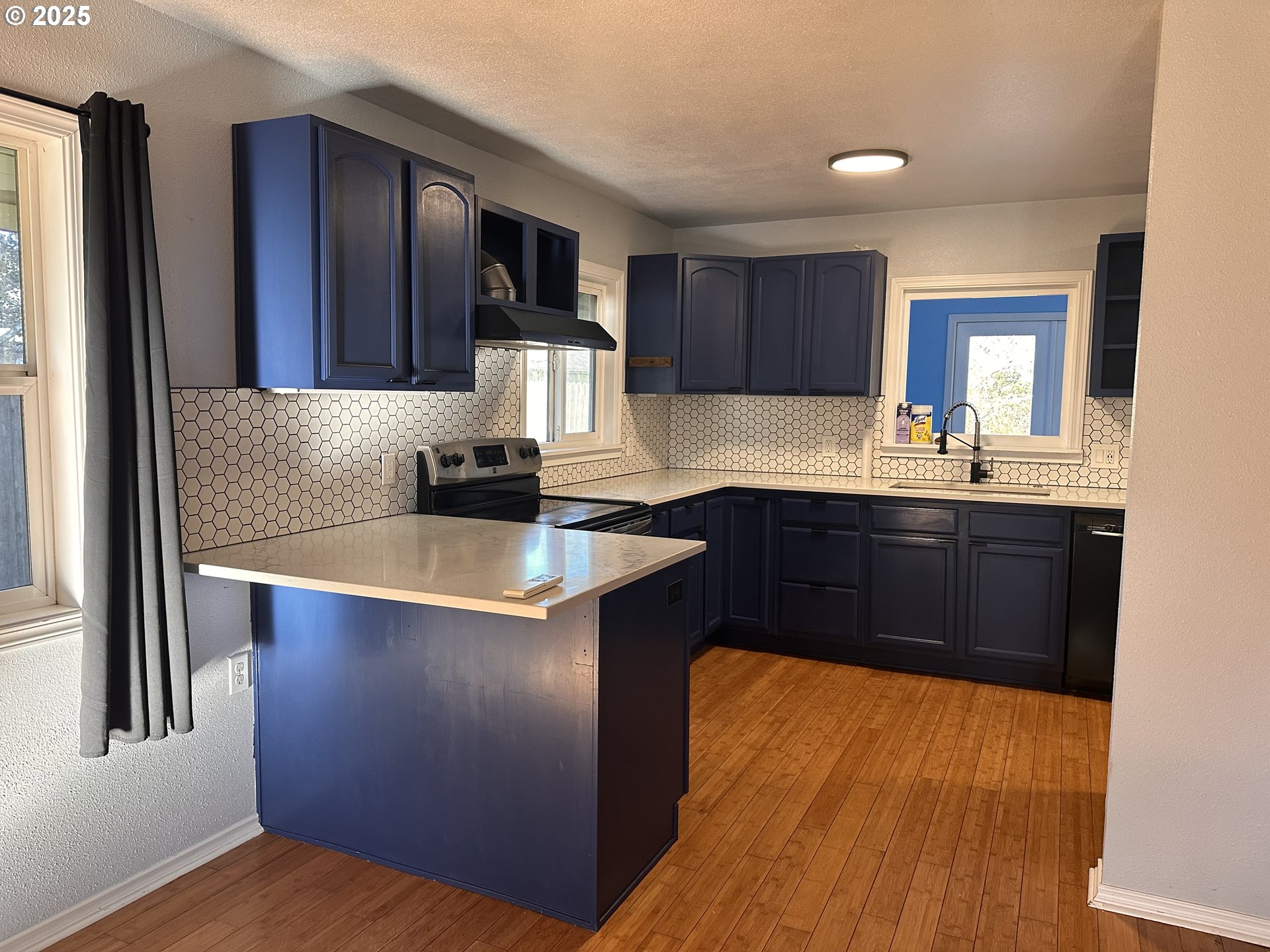 1335 7th Street Florence, OR 97439 - Photo 11 of 39 a kitchen with stainless steel appliances granite countertop a sink stove and refrigerator