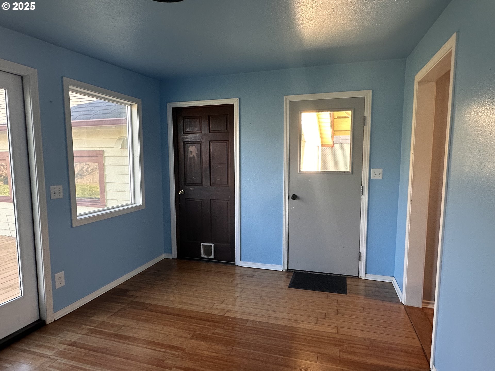 1335 7th Street Florence, OR 97439 - Photo 22 of 39 a view of an empty room with wooden floor and a window