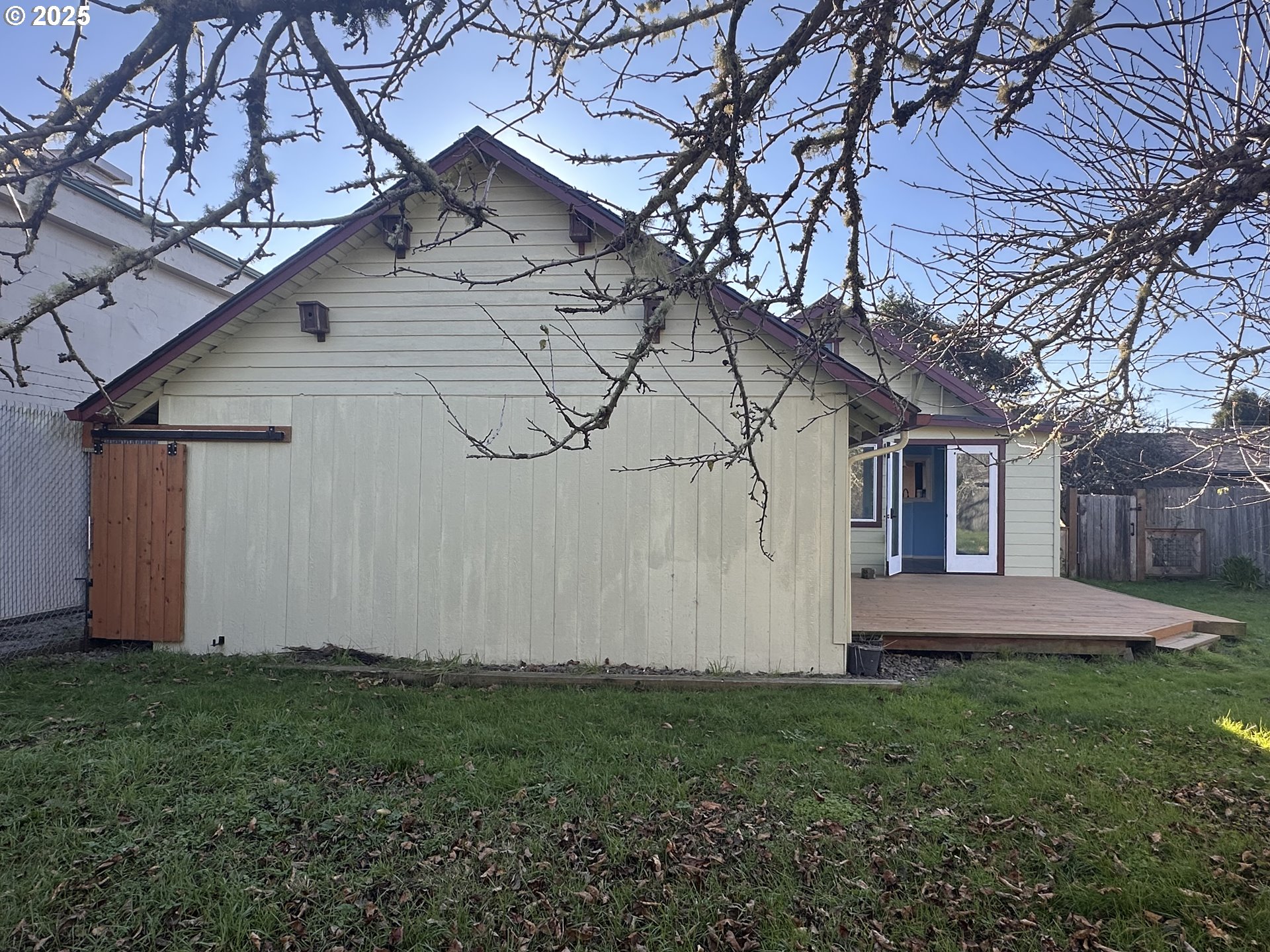 1335 7th Street Florence, OR 97439 - Photo 26 of 39 a view of a house with a yard