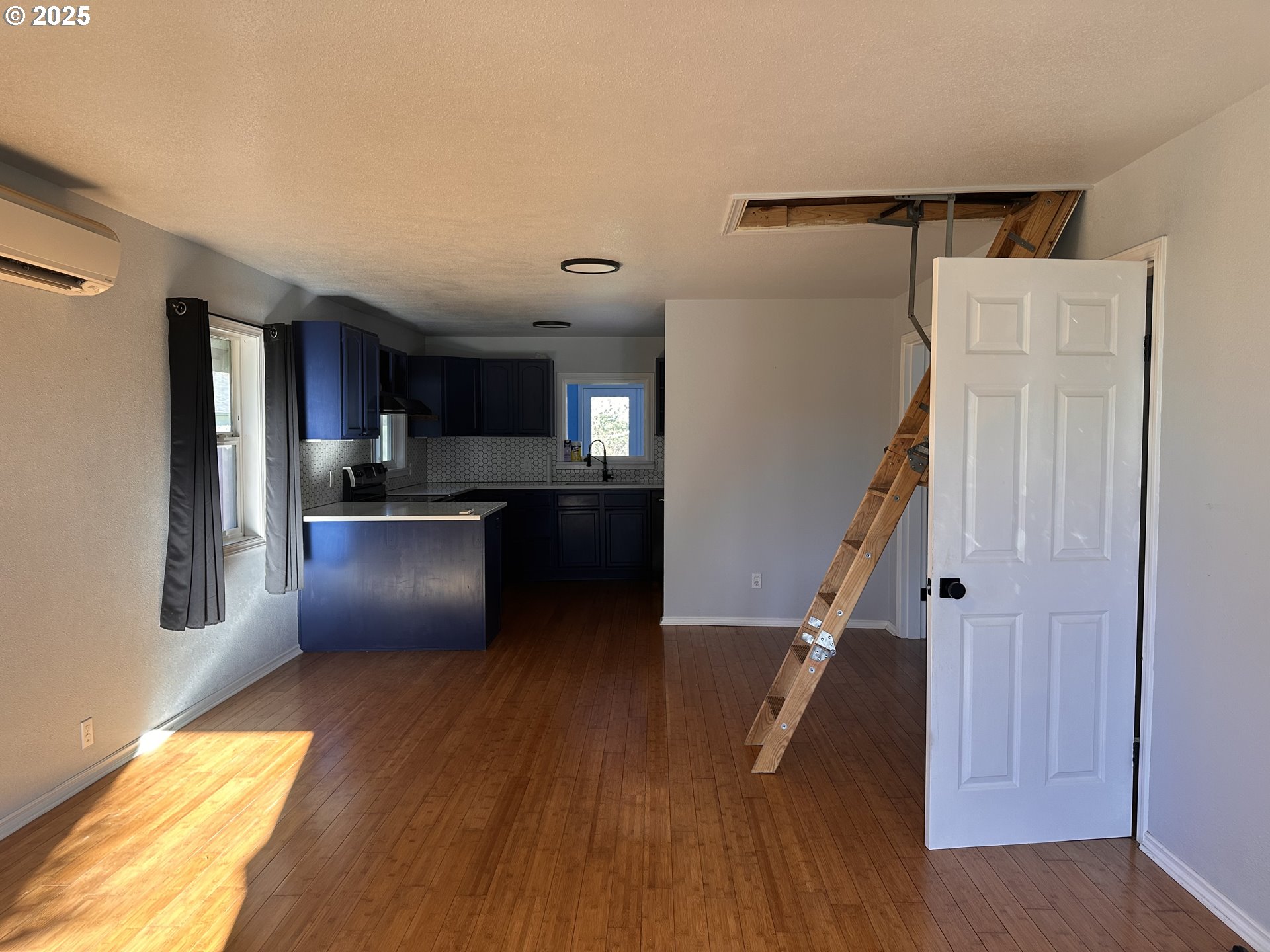 1335 7th Street Florence, OR 97439 - Photo 32 of 39 a kitchen with kitchen island wooden floor and stainless steel appliances