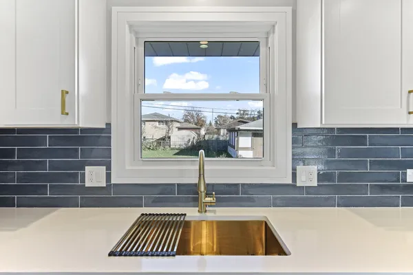 a kitchen with appliances a sink and cabinets