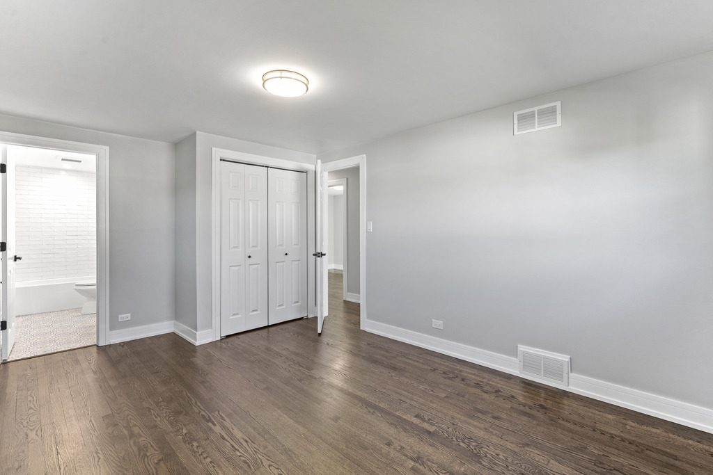 8409 Newland Avenue Burbank, IL 60459 - Photo 16 of 32 a view of an empty room with wooden floor
