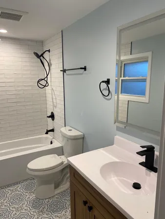 a bathroom with a toilet and a bath tub