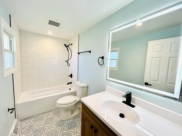 a bathroom with a sink a toilet and a bathtub