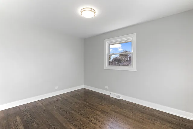 a view of an empty room and wooden floor