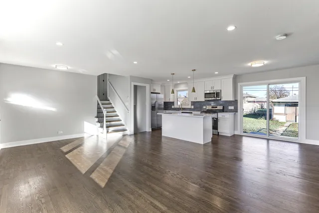 a view of kitchen with cabinets and wooden floor