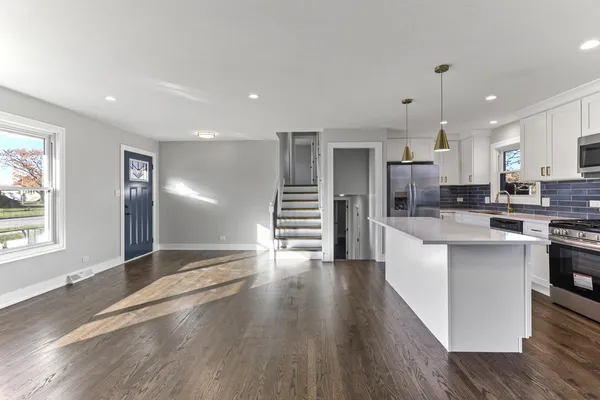 a view of kitchen with sink and wooden floor
