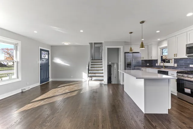 a view of kitchen with sink and wooden floor