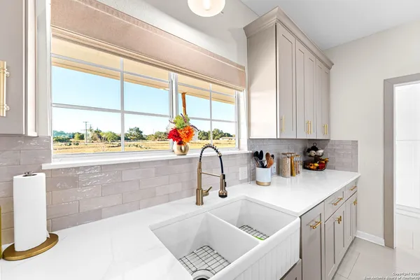 a kitchen with a sink a stove and cabinets