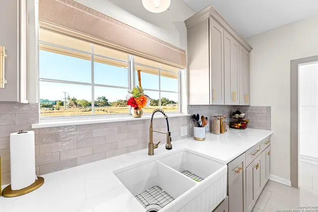 a kitchen with a sink a stove and cabinets