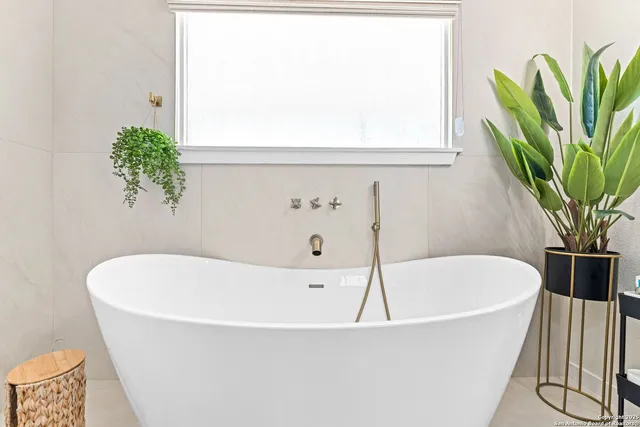 a white bath tub with a window