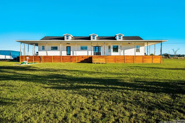 a front view of a house with a big yard
