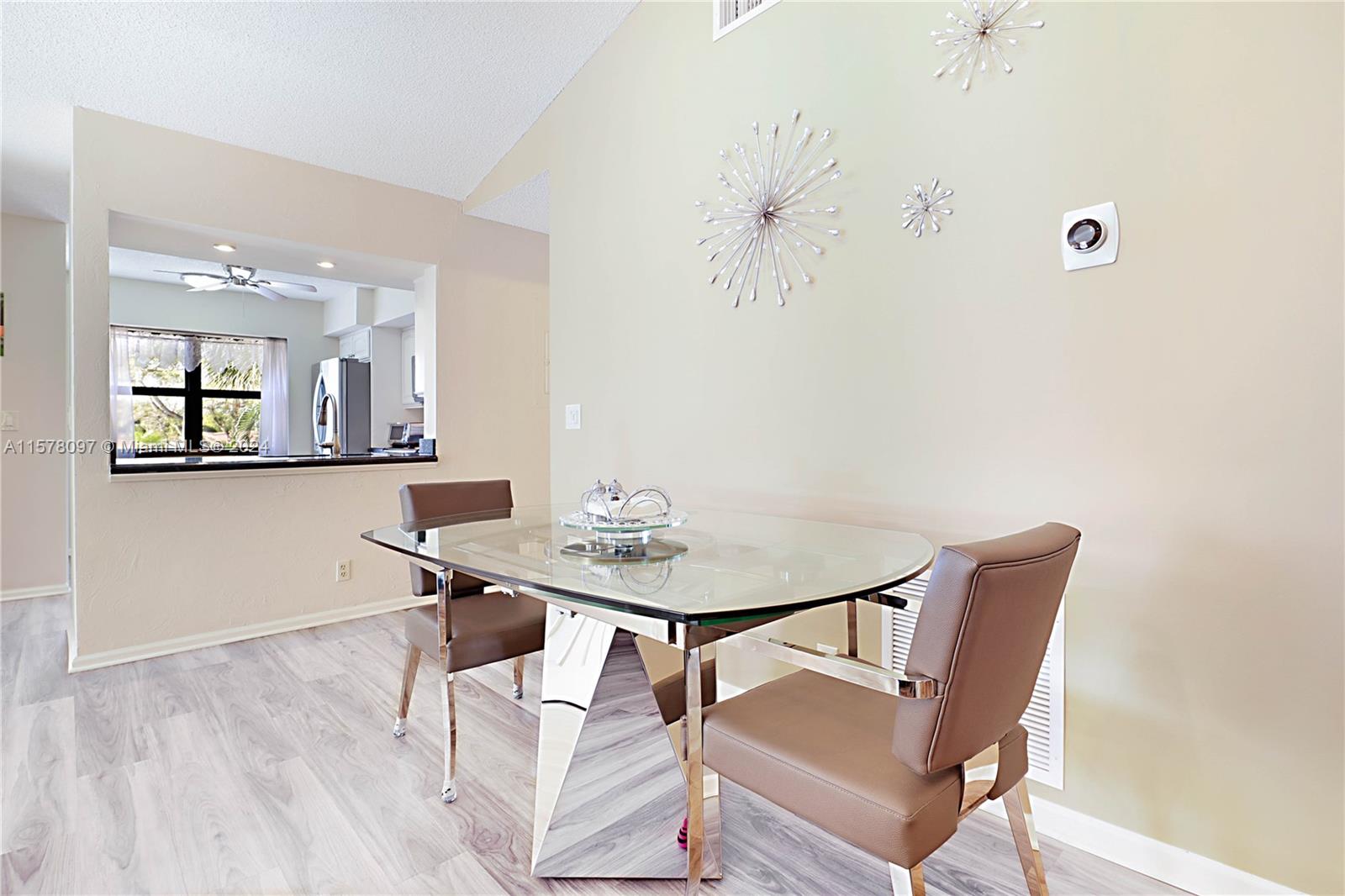7864 Granada Place, Unit 504 Boca Raton, FL 33433 - Photo 13 of 65 a view of a dining room with furniture and wooden floor