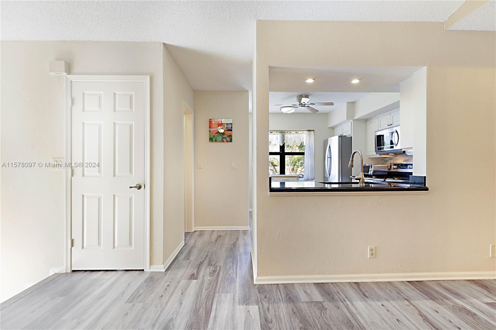 7864 Granada Place, Unit 504 Boca Raton, FL 33433 - Photo 16 of 65 a view of a kitchen with wooden floor and a window