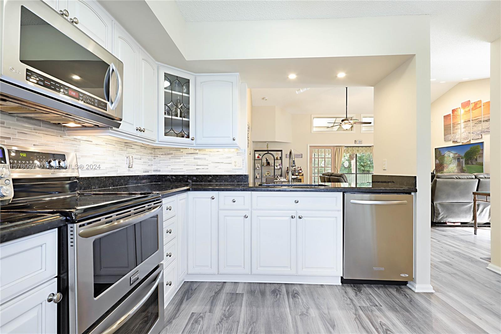7864 Granada Place, Unit 504 Boca Raton, FL 33433 - Photo 23 of 65 a kitchen with a stove a sink and a refrigerator