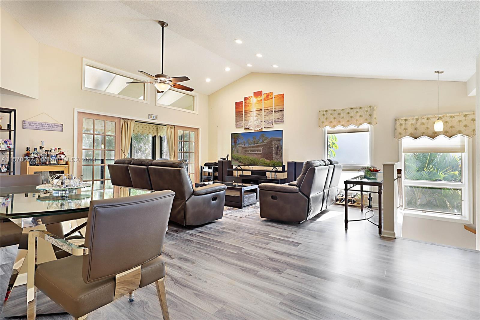 7864 Granada Place, Unit 504 Boca Raton, FL 33433 - Photo 25 of 65 a living room with furniture a dining table and a floor to ceiling window